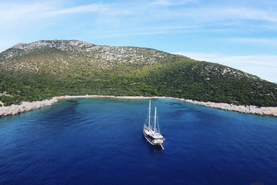 Karaada and the islands of Bodrum Bay viewed from a luxury yacht, featuring crystal-clear turquoise waters, secluded coves and the stunning Aegean coastline.