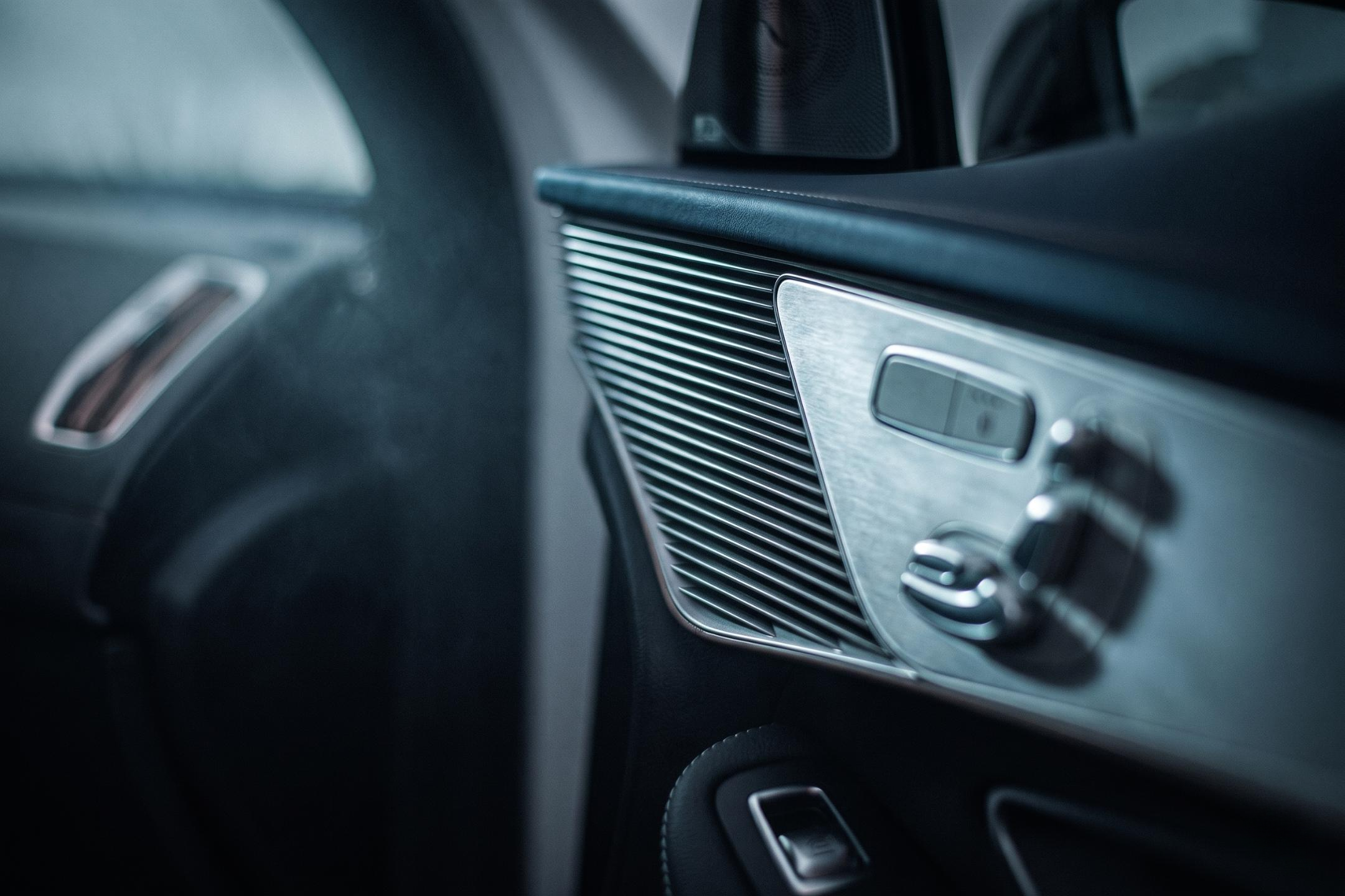Close-up of a modern car interior of a Mercedes Eqc 400 focusing on the dashboard and center console, with metallic and black accents.