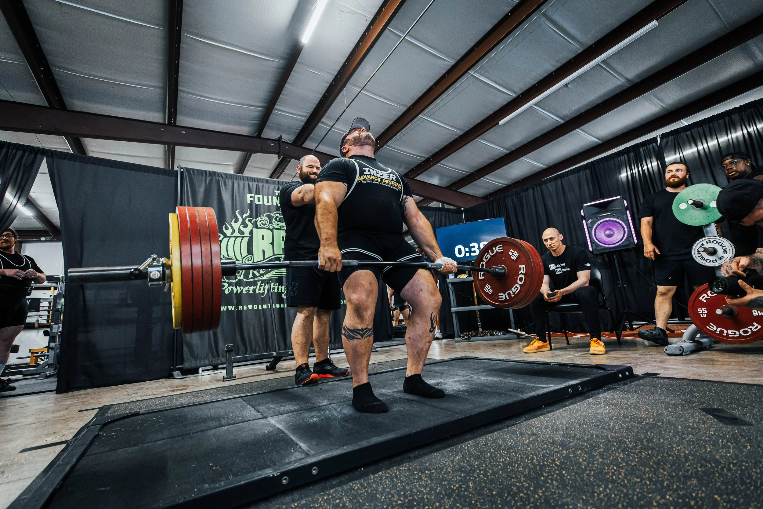 Lifter locking out a barbell deadlift at a powerlifting meet at The Foundry Barbell in Greenville, NC