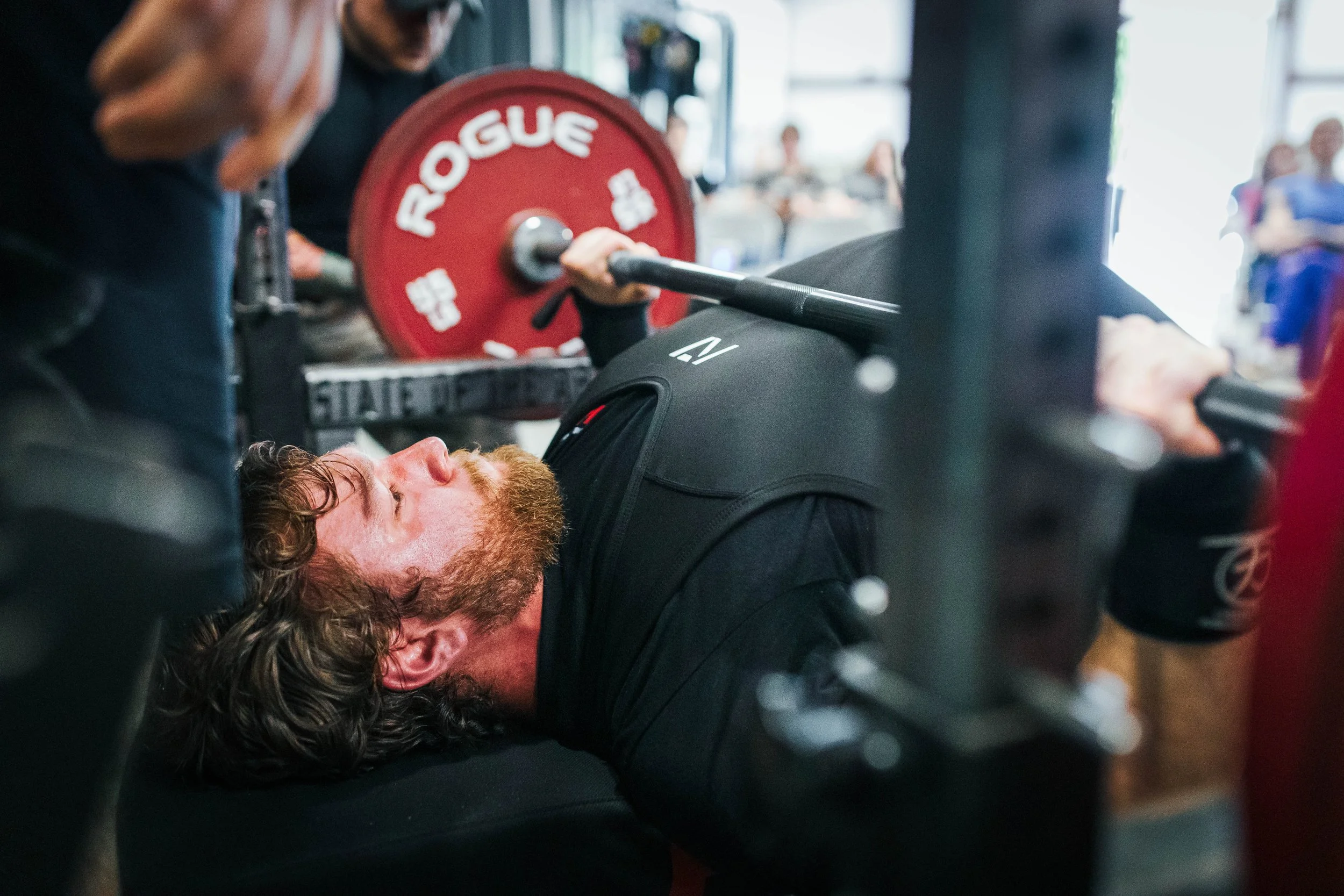 Lifter performing a barbell bench press at The Foundry Barbell, a powerlifting gym in Greenville, NC