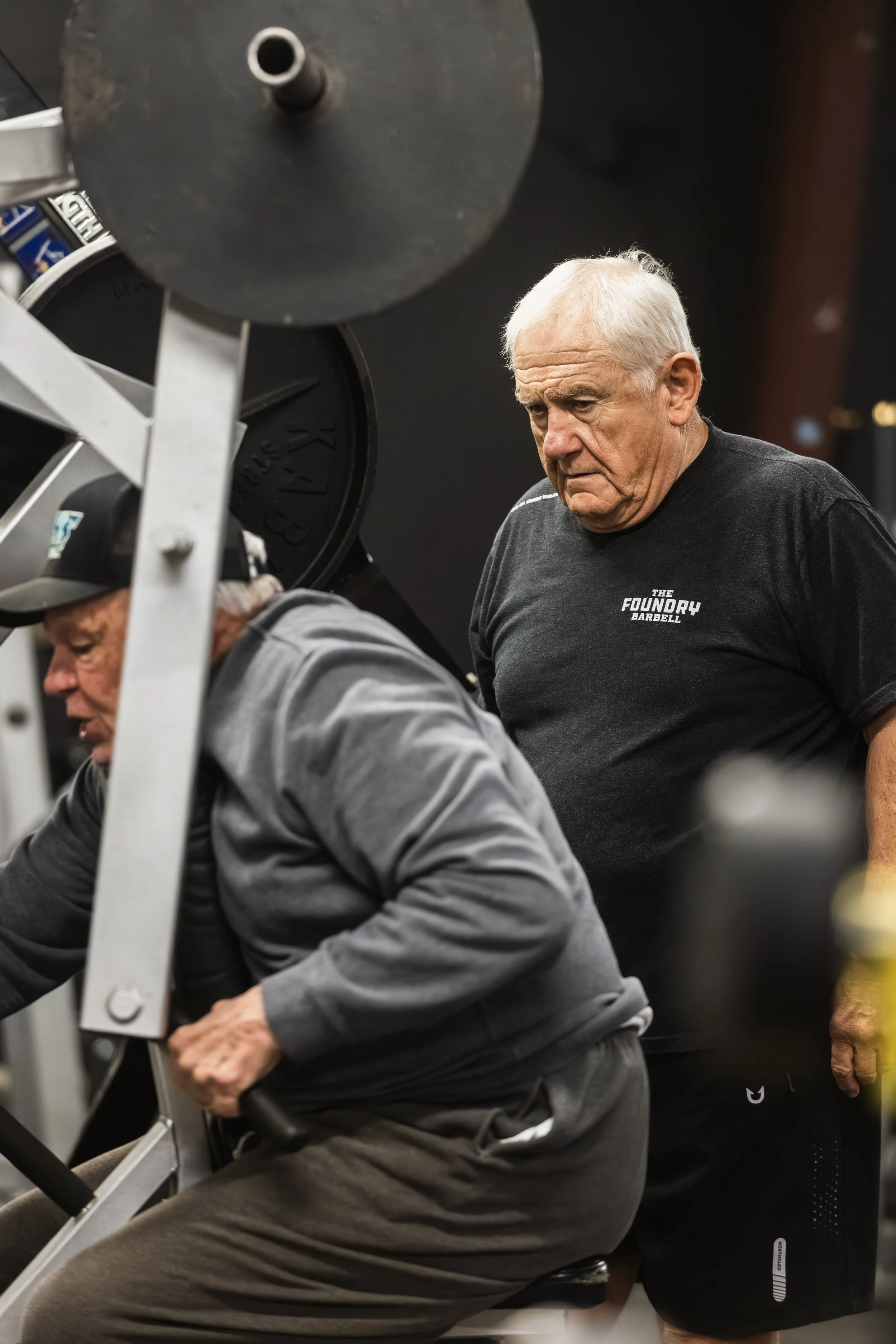 Coach spotting a member on a low row at The Foundry Barbell, a powerlifting gym in Greenville, NC