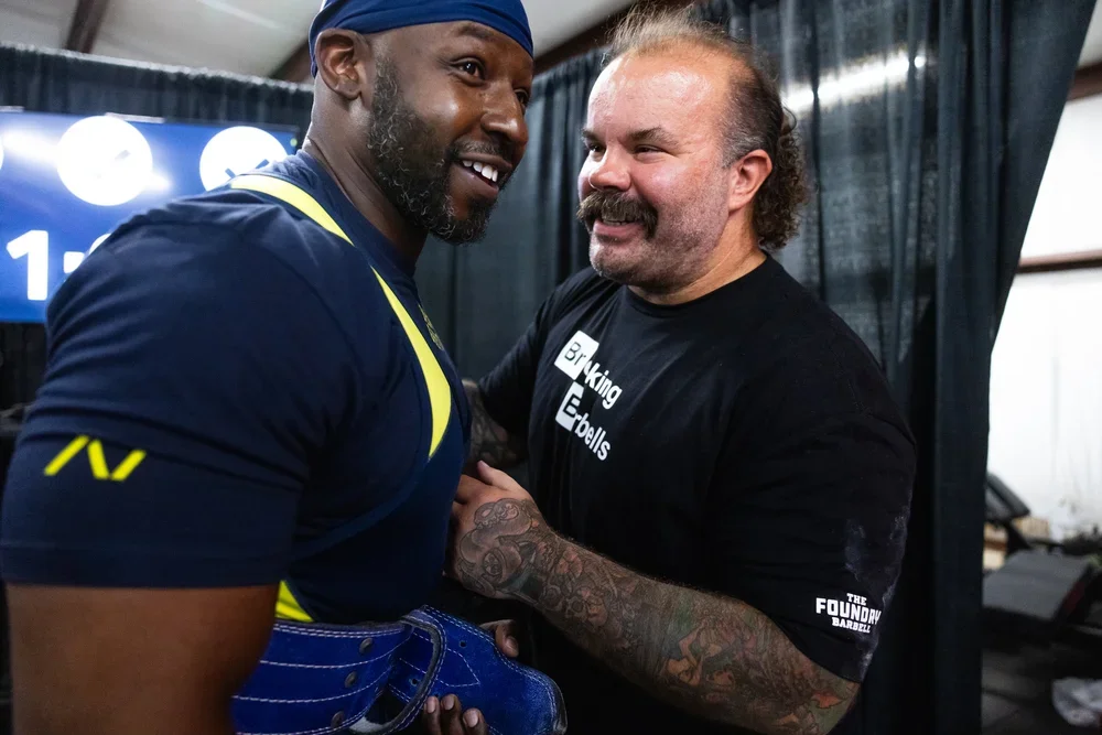 Coach Skyler greeting an athlete at The Foundry Barbell, a powerlifting gym in Greenville, NC