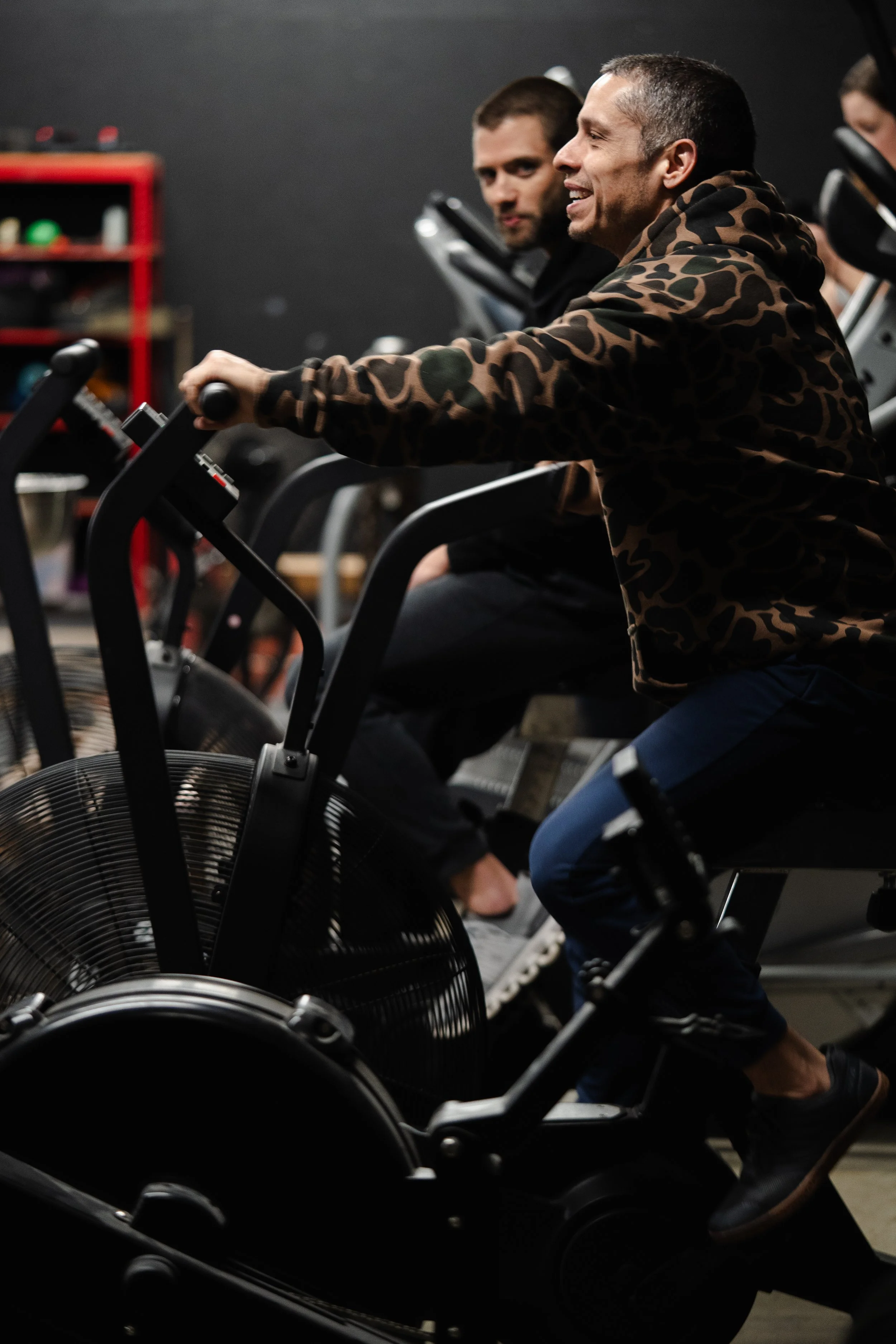 Members training on air bikes during a conditioning workout at The Foundry Barbell in Greenville, NC