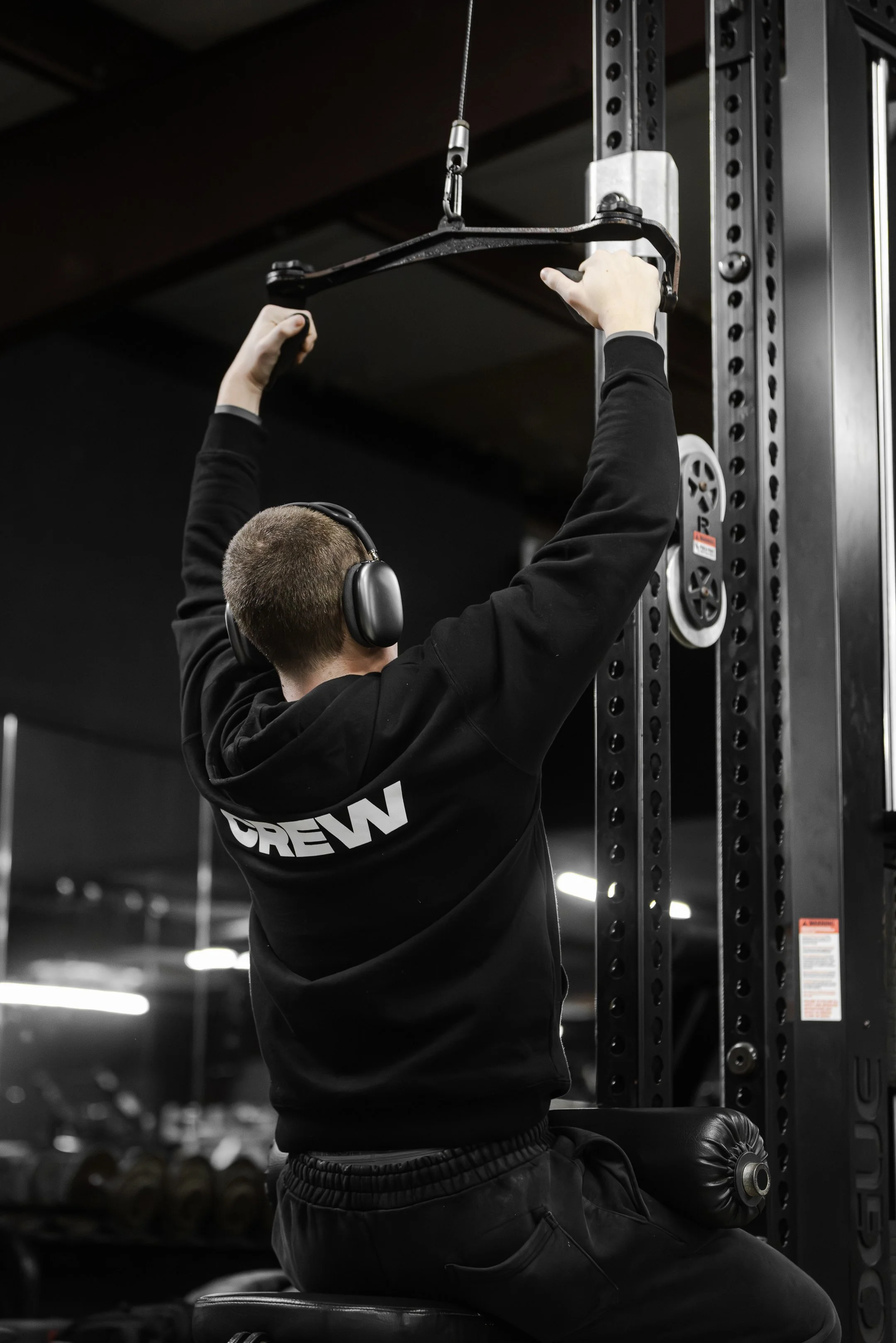 Member performing a lat pulldown during strength training at The Foundry Barbell in Greenville, NC