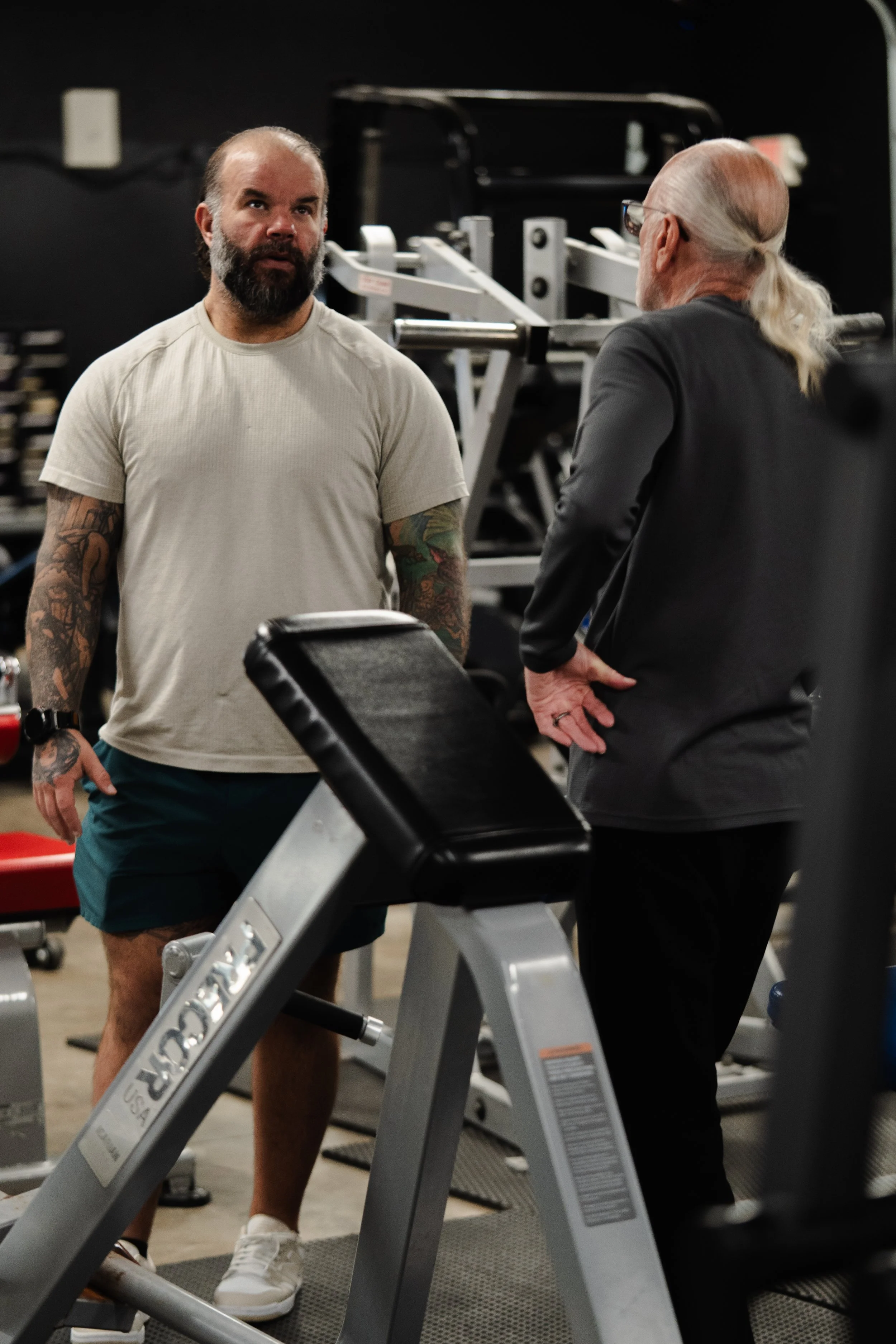 Coach Skyler working with a member on the gym floor at The Foundry Barbell in Greenville, NC