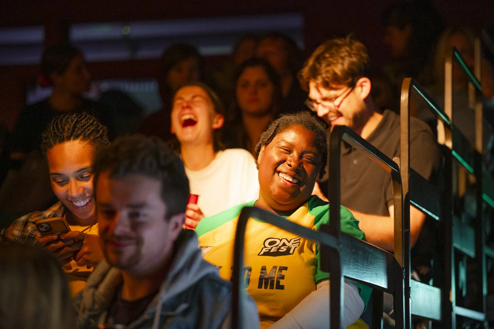 Young people in the audience laughing