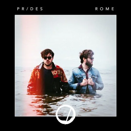 Two men standing in water with a cloudy sky in the background, wearing jackets and sunglasses, with the text 'PRIDES' and 'ROME' at the top.