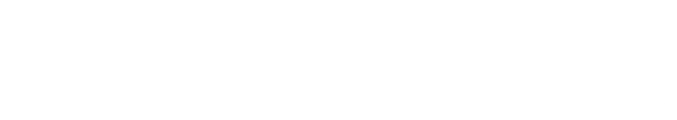 A black and white photo of a woman in a hat and sunglasses sitting by a body of water.