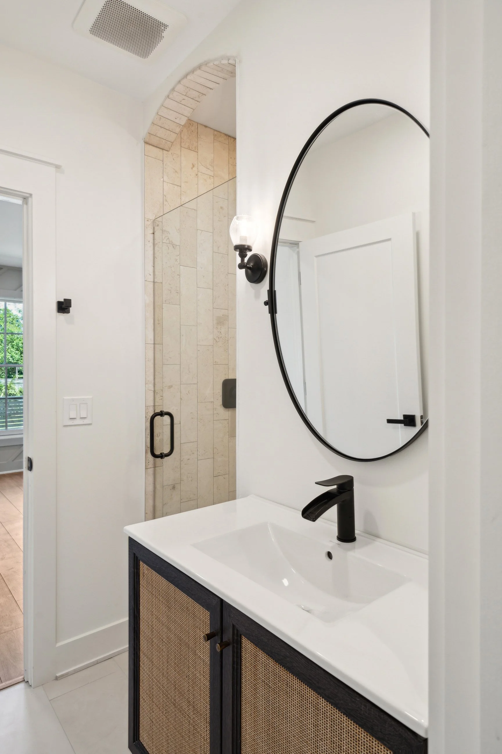 modern bathroom with circular mirror and custom vanity