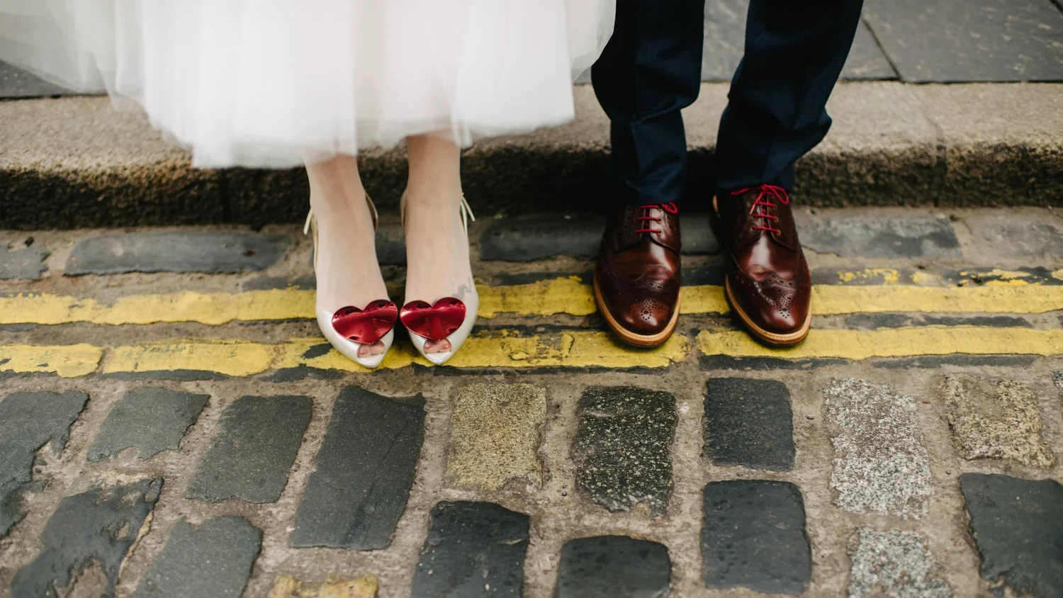 Bride shoes with shiny red hearts photographed on the streets of Belfast