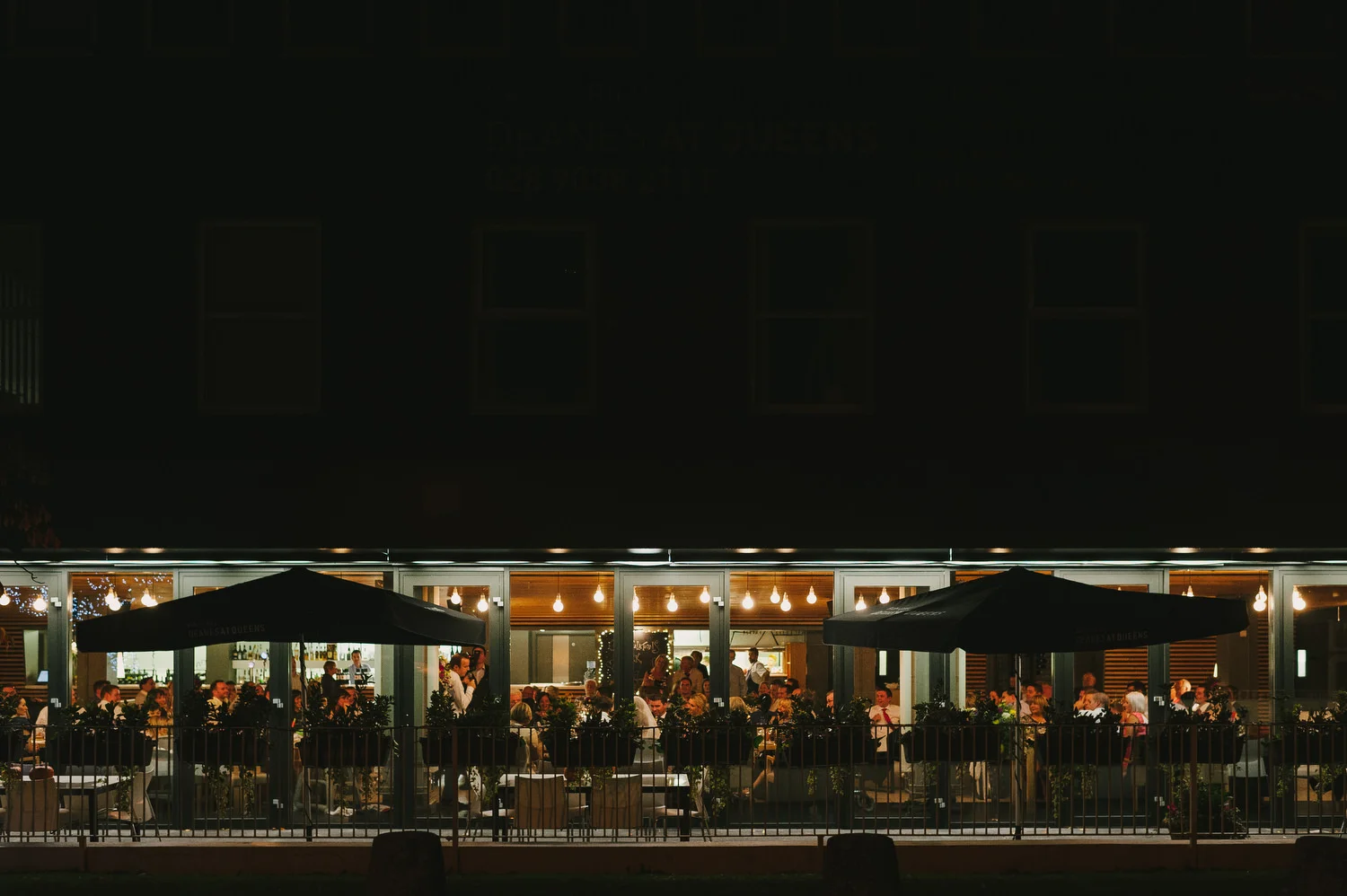 Deane's at Queens exterior photographed at a wedding at night.