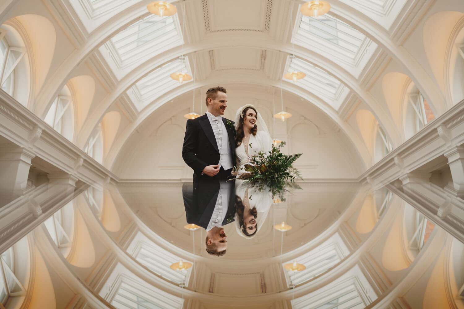 A couple photographed in the drawing room at their wedding in Titanic Hotel in Belfast