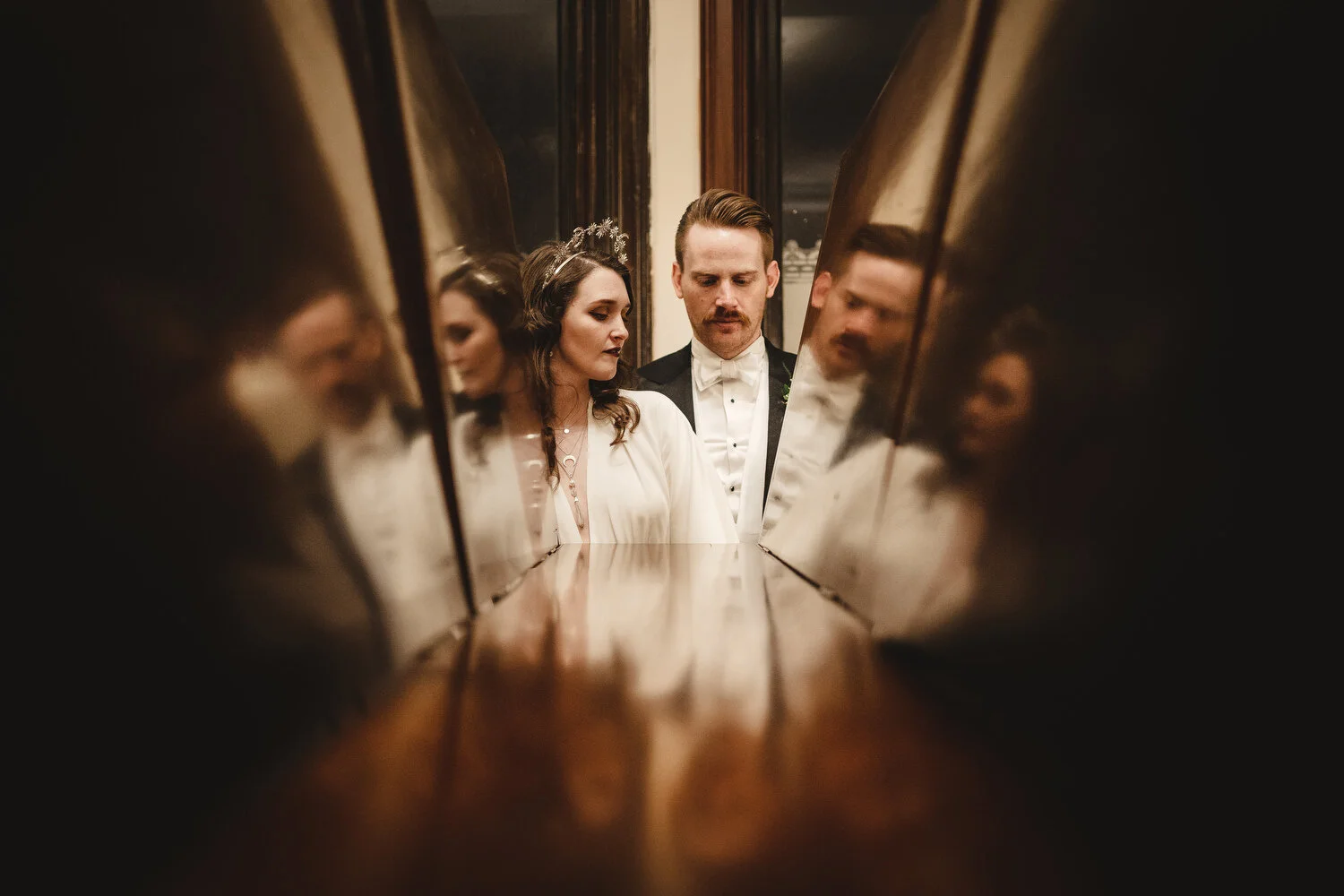 A quirky photograph of a couple at their wedding in Titanic Museum in Belfast