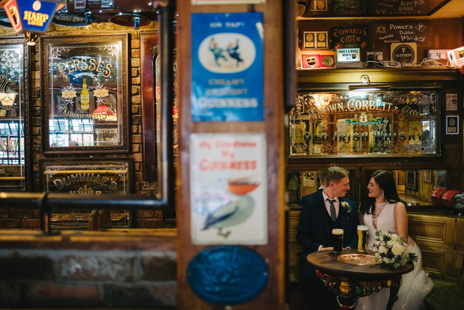 A couple posing for wedding photos inside The Duke of York pub in belfast