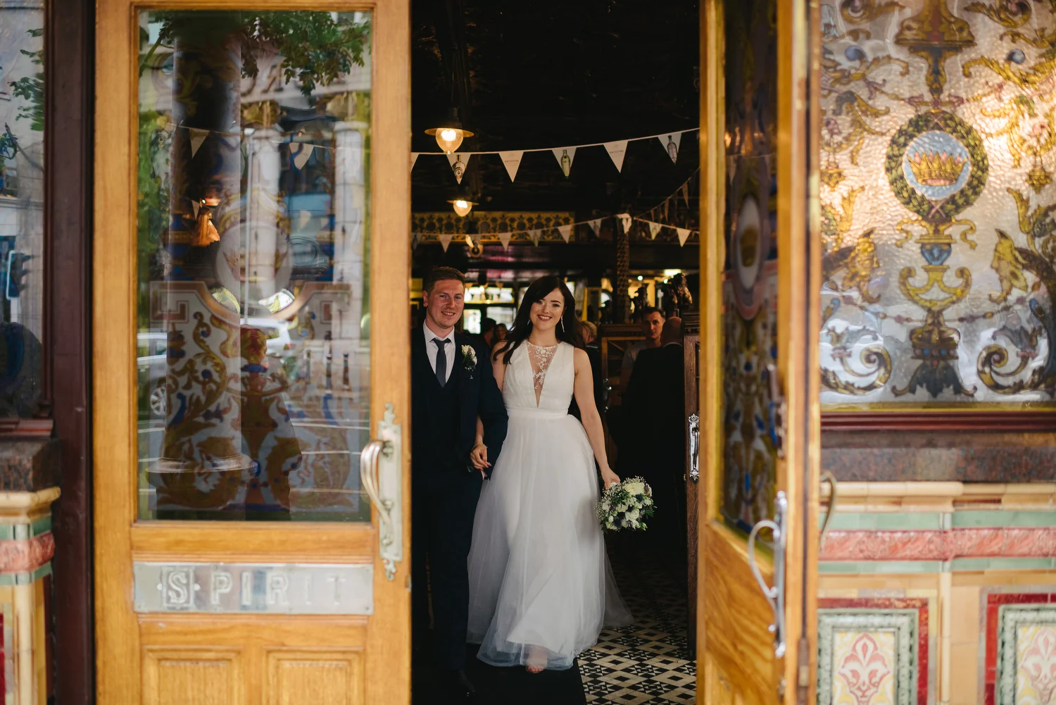 A couple having their wedding photos inside the Crown Bar in Belfast