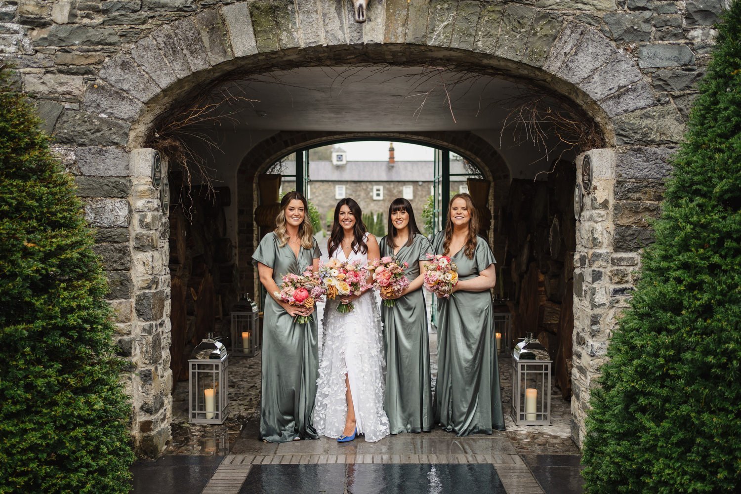 Bridesmaids sheltered from the rain at a wedding in Virginia Park Lodge