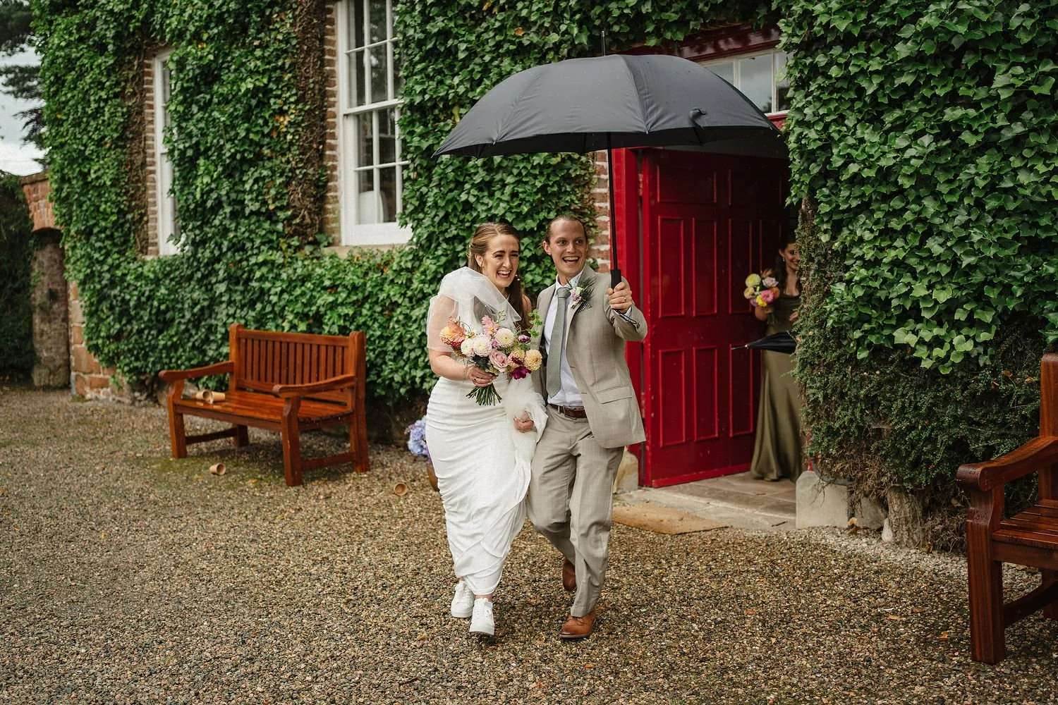 A couple enjoying their rainy wedding at the Old Rectory in Killyman, Northern Ireland