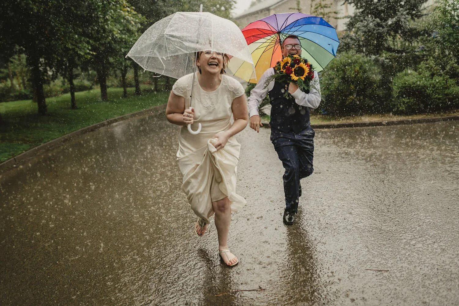 A couple caught out in a storm running with umbrellas in Northern Ireland