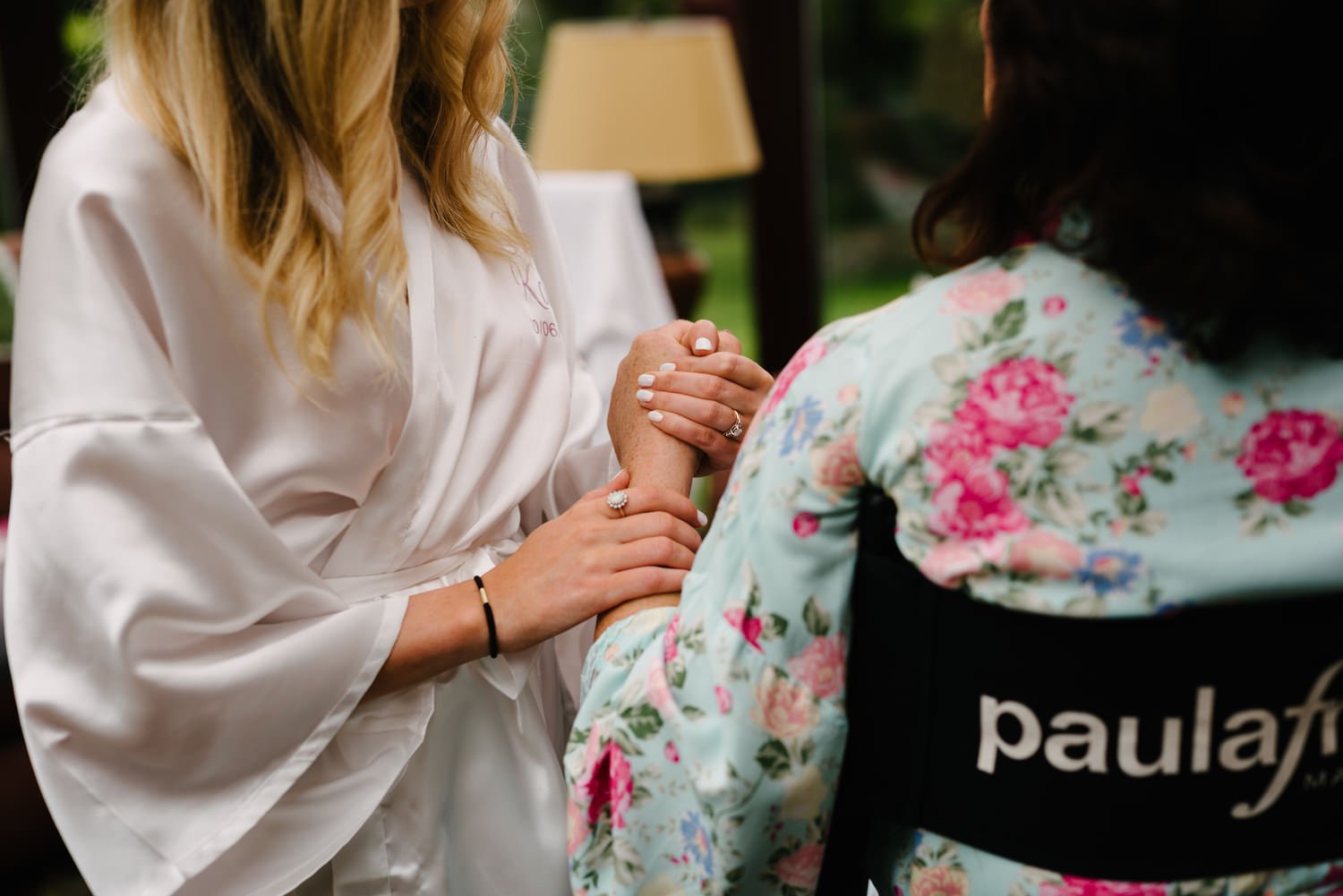 Bride holding her mother's hand on her wedding morning in Harvey's Point Donegal