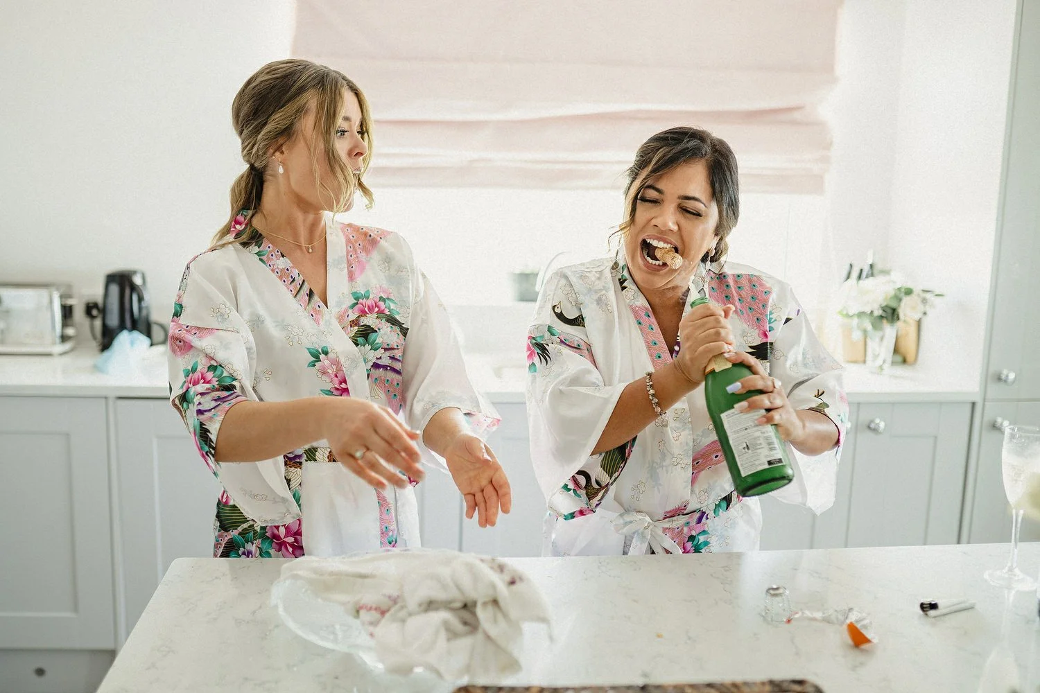 Funny photo of a bridesmaid opening champagne bottle with her teeth