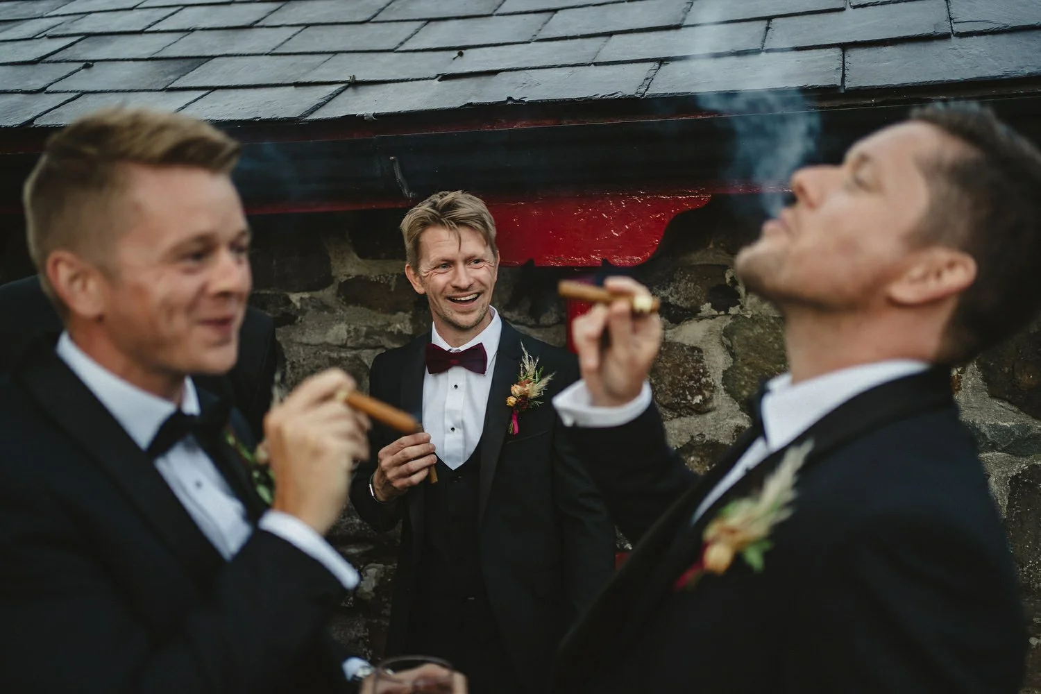 Groomsmen enjoying cigars at a wedding in Larchfield Estate in Northern Ireland