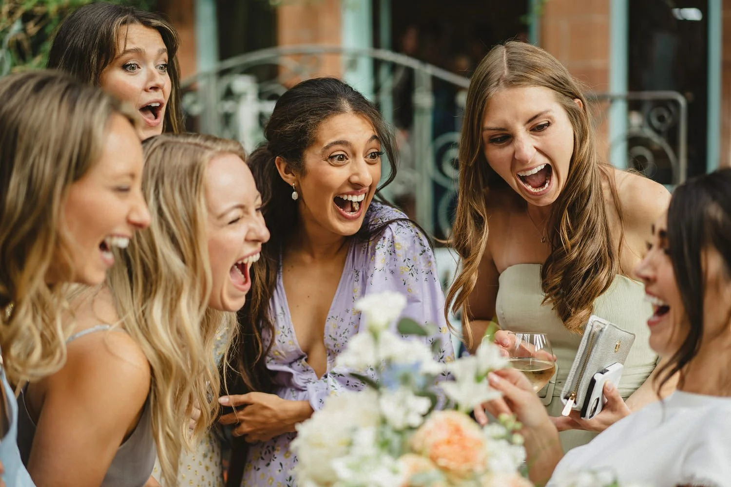 A bride and her close friends laughing at a wedding in Castle Leslie Estate in Ireland