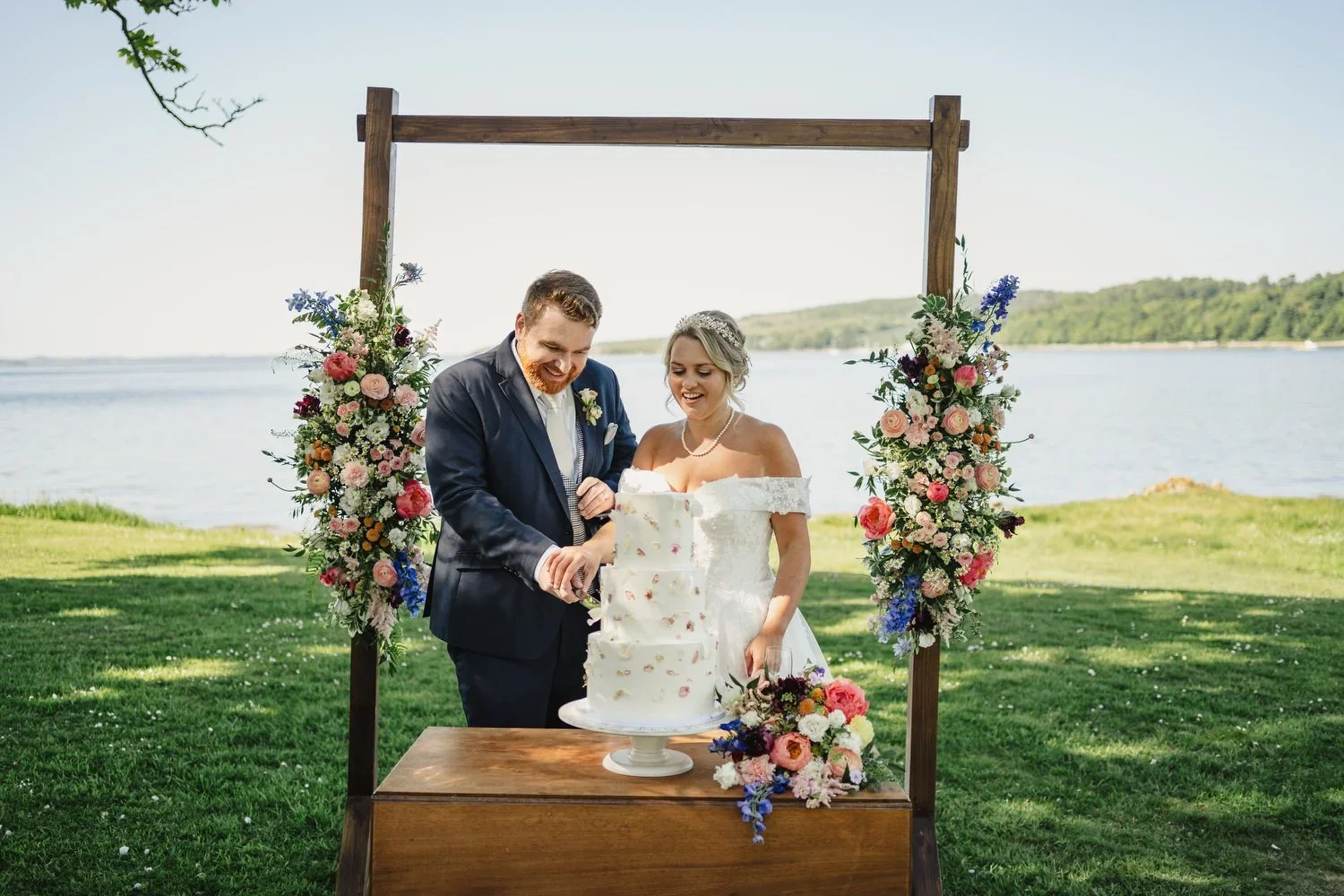 Couple cutting their cake outdoors at Old Court Strangford
