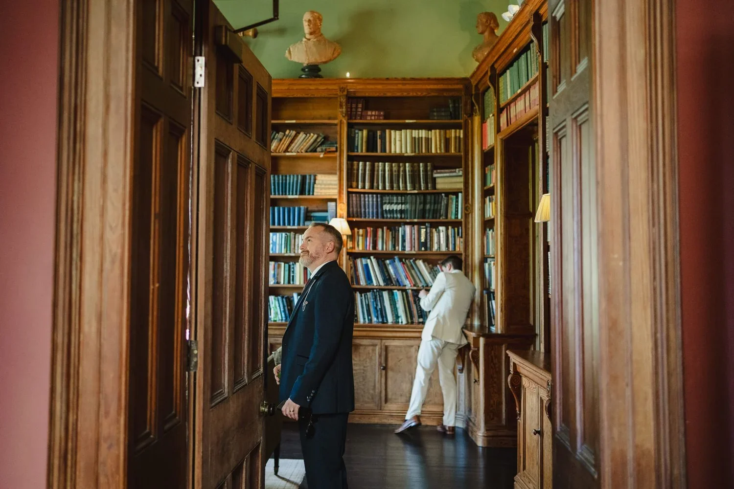 Wedding guests explore the library at Castle Leslie