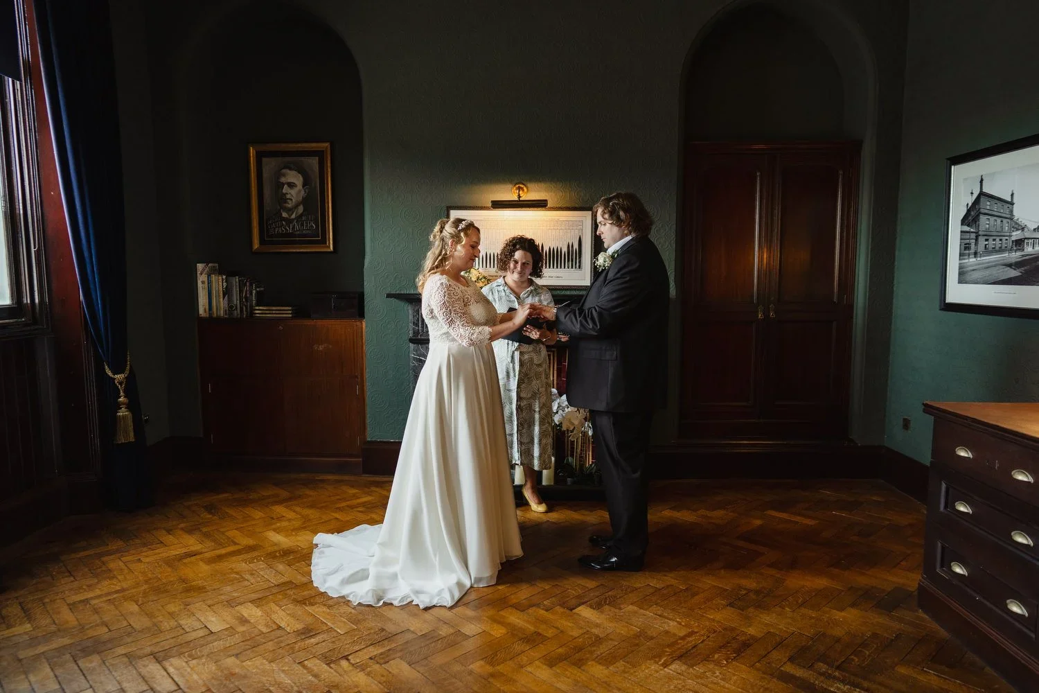 A couple exchange rings at their elopement in the Thomas Andrews office at Titanic Hotel Belfast.