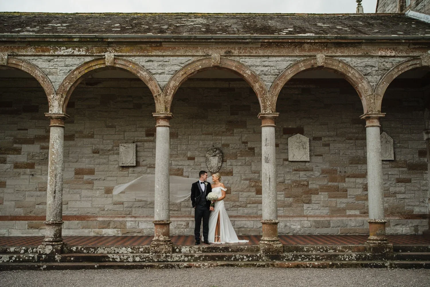 Wedding Portraits in the Exterior of Castle Leslie with arches in the background