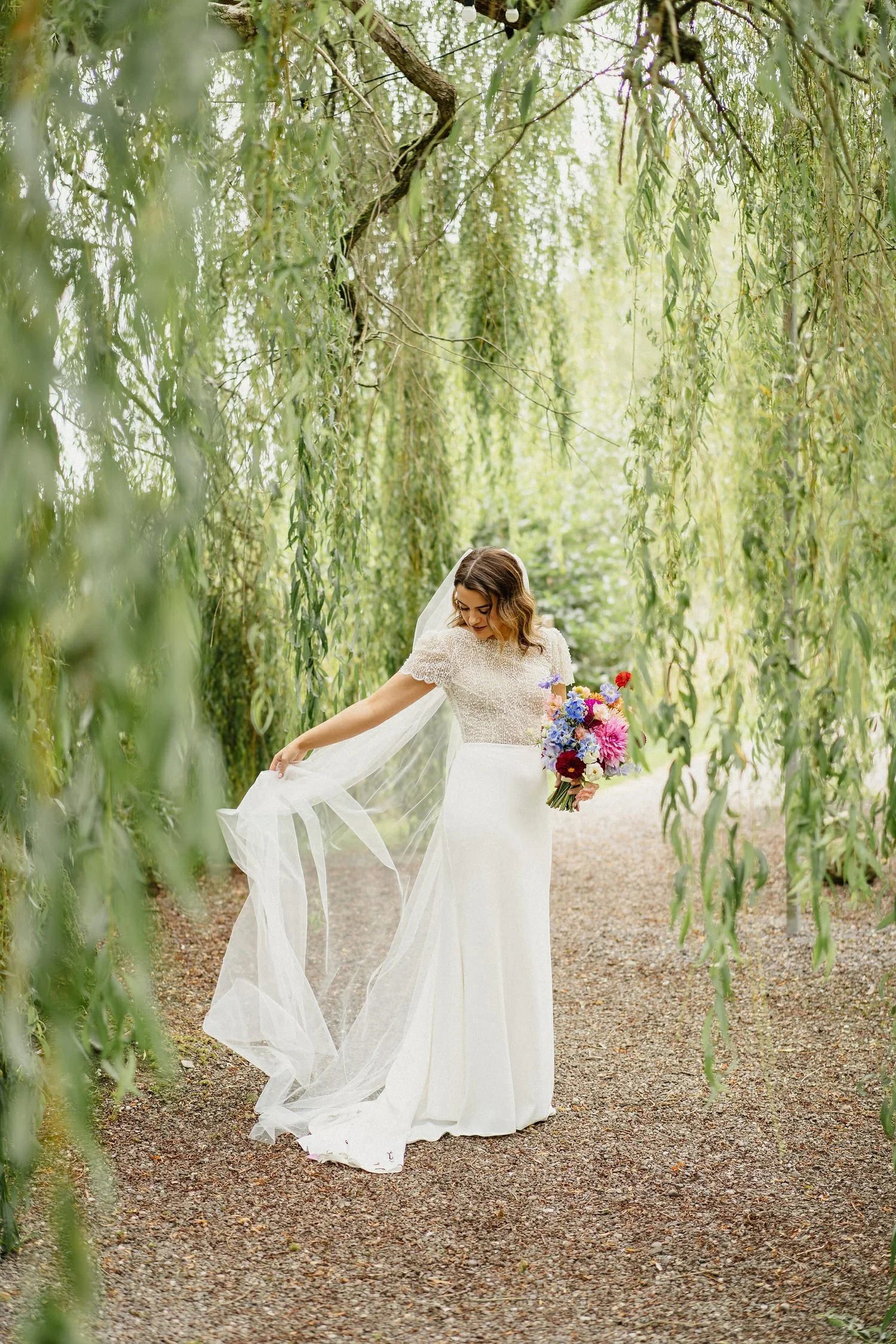A bride photographed among the branches of a weeping willow tree at castle leslie