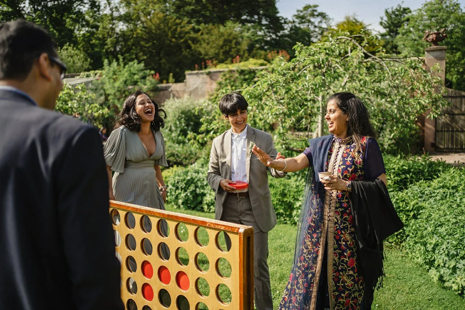 Guests at larchfield estate playing lawn games.