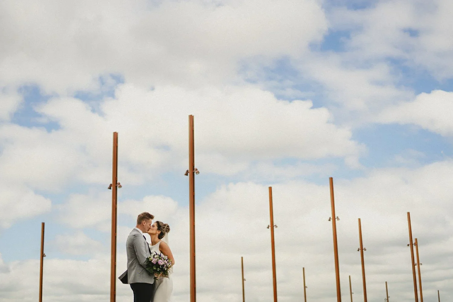 A bride and groom kiss on titanic slipway in Belfast