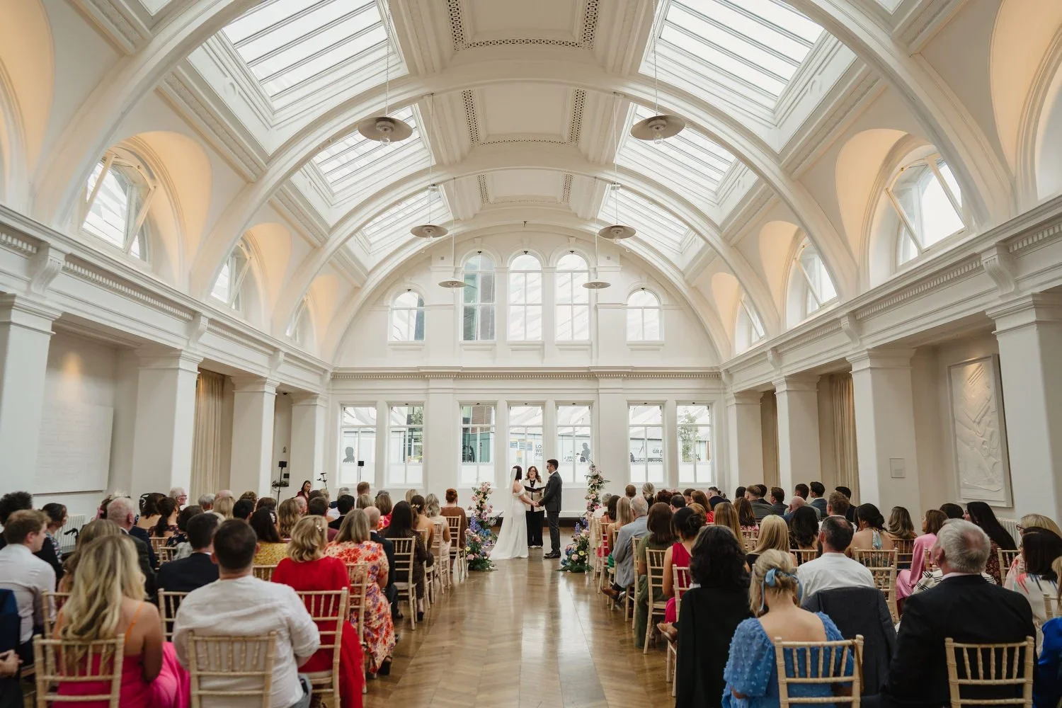 A wedding ceremony in Drawing Office One in Titanic Hotel Belfast with gorgeous high ceilings and natural light