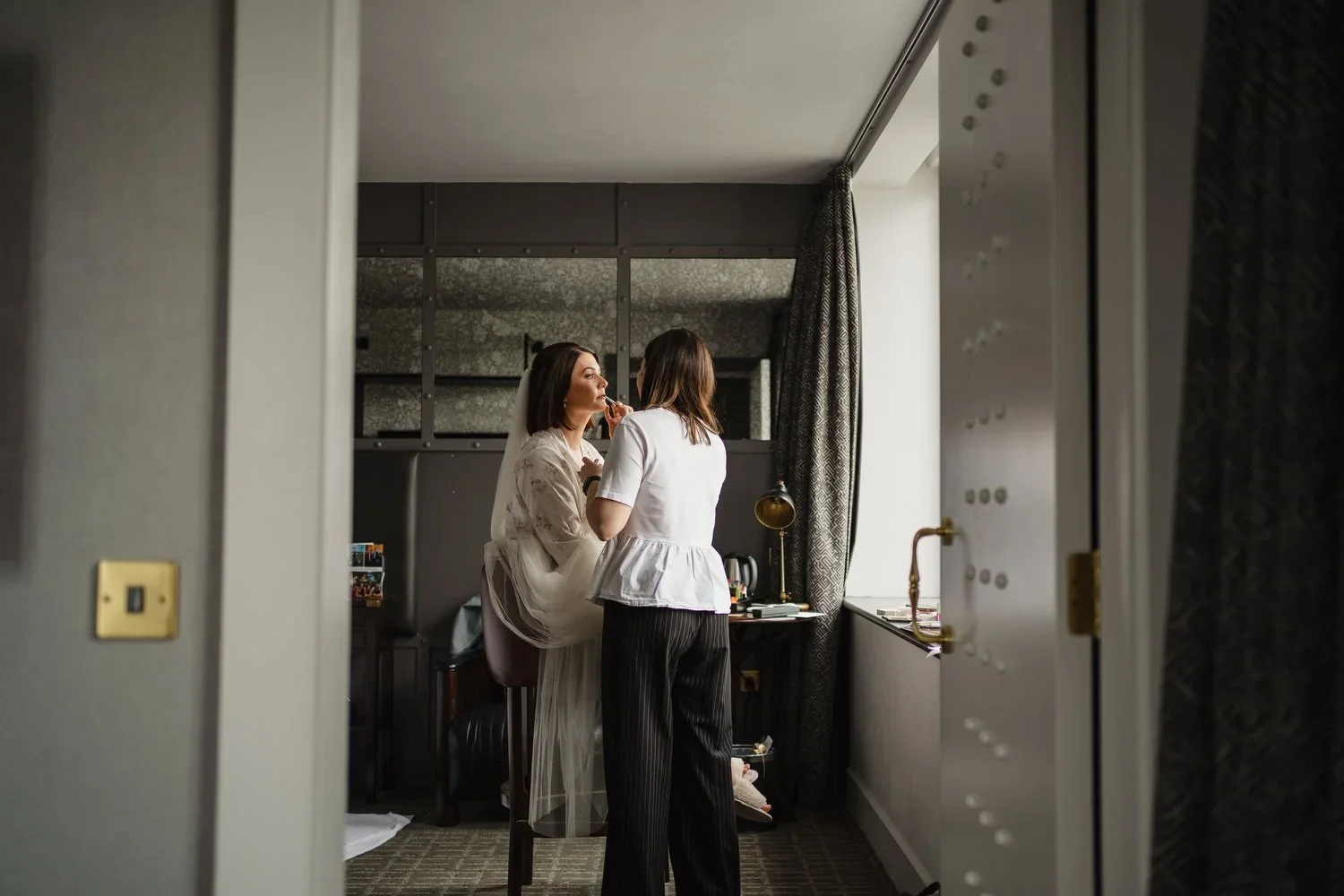 A bride getting her makeup done in a room at the Titanic Hotel in Belfast