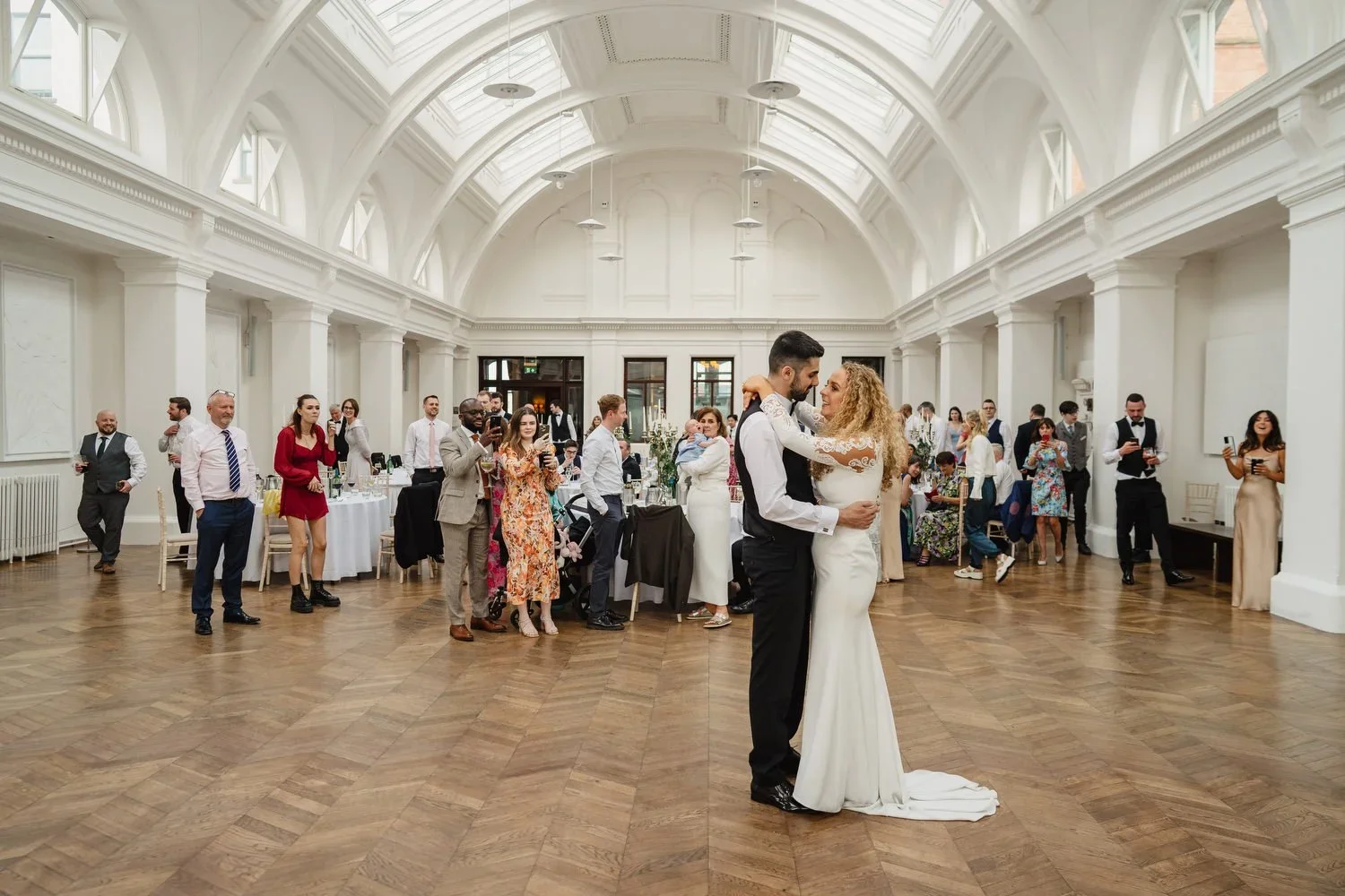A bride and groom have their first dance in Drawing Office One at Titanic Hotel
