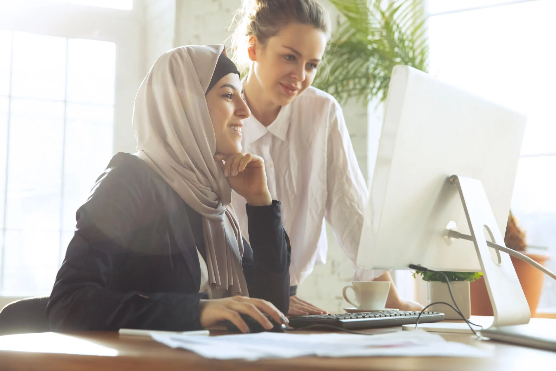 Professional office workers using computers in a workplace