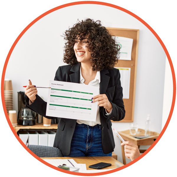 Female project manager presenting a chart to colleagues in a meeting