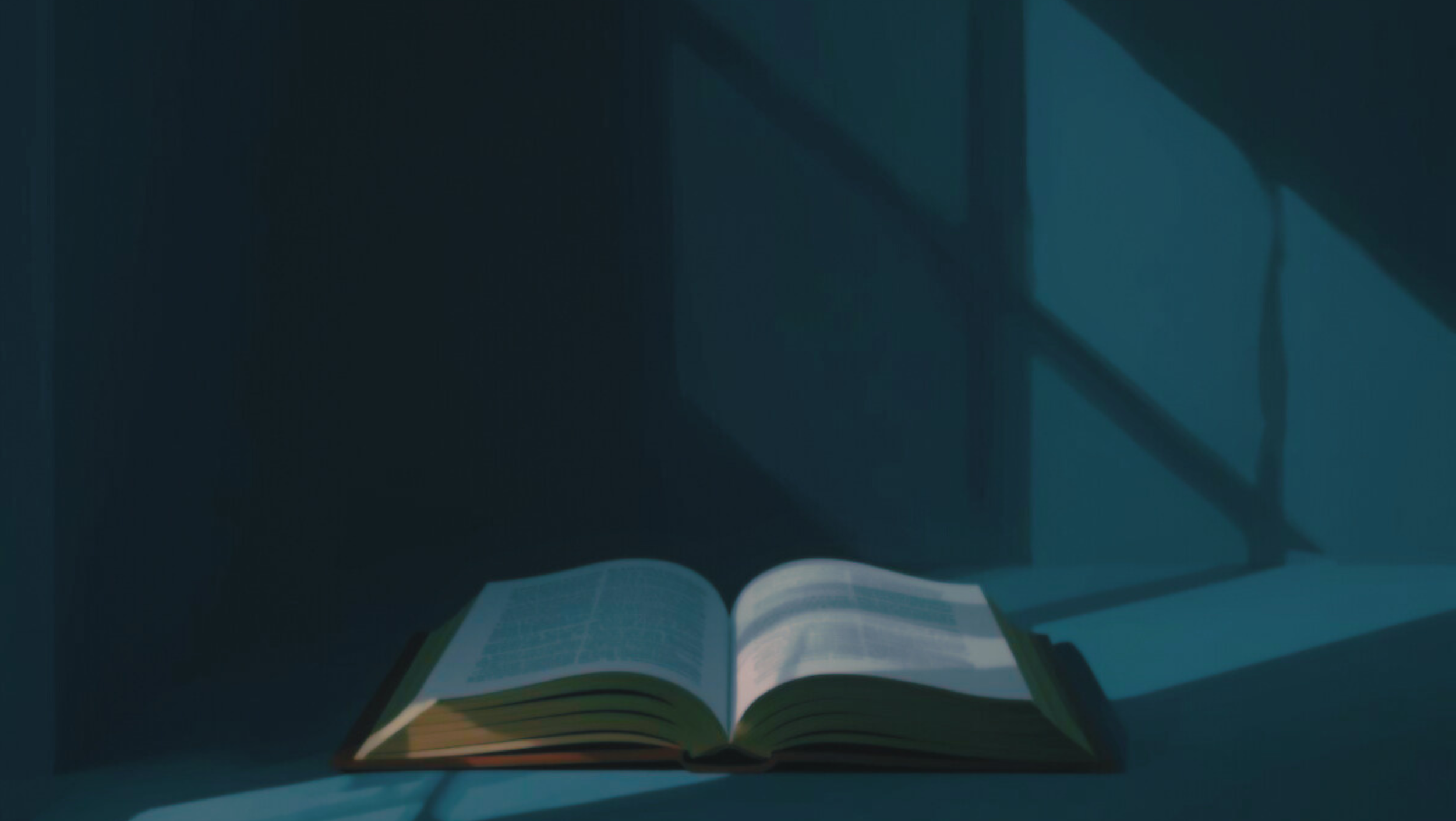 An open book on a table in a dimly lit room with sunlight coming through a window and casting shadows.