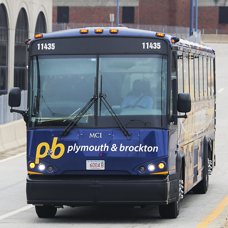Front view of a blue shuttle bus with 'Plymouth & Brockton' written on it, number 11435, parked on a city street.