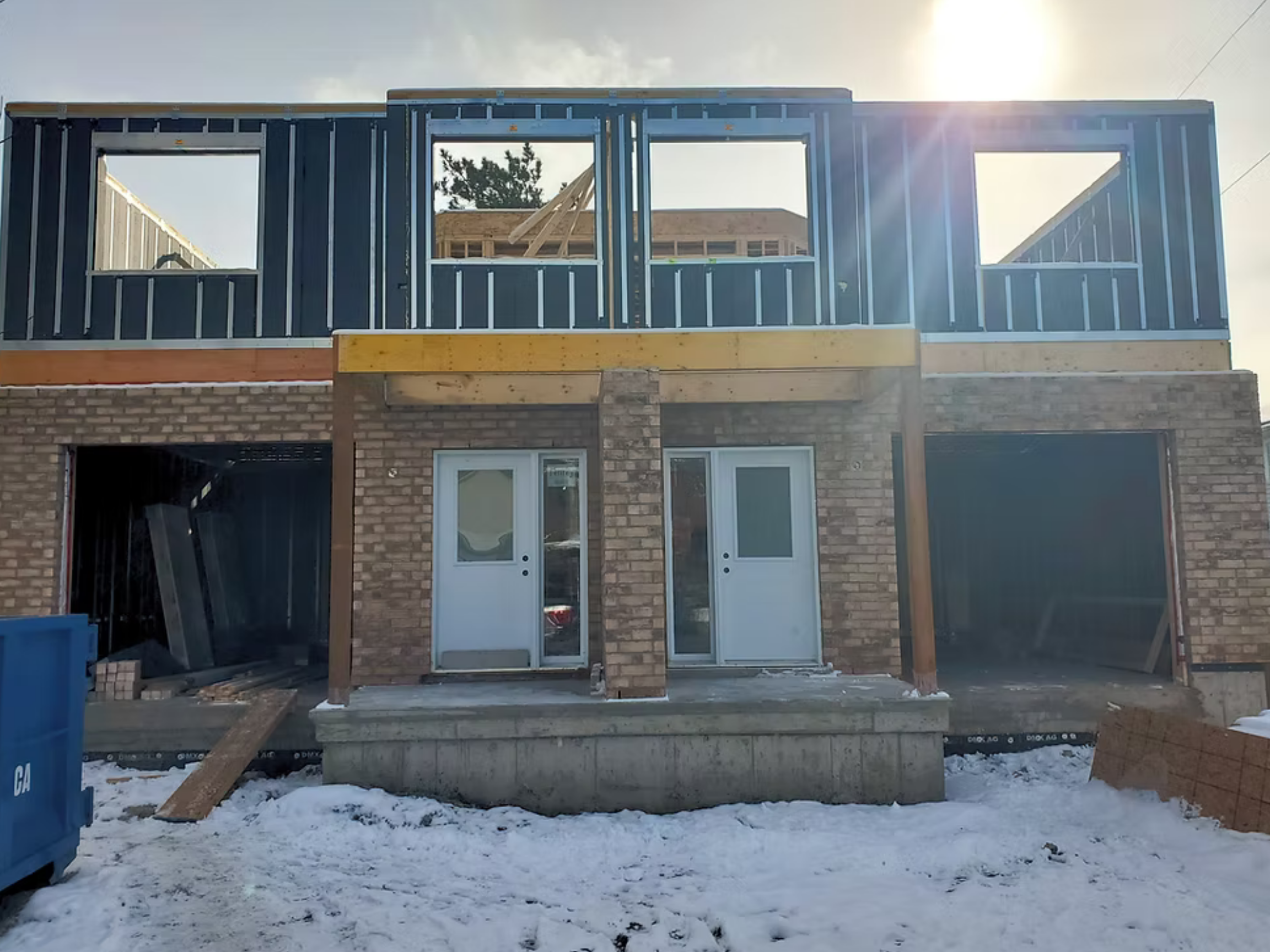 A cropped exterior image of "St Stephen's urband duplex build using the HARMONIC building envlope unfinished in thw winter.