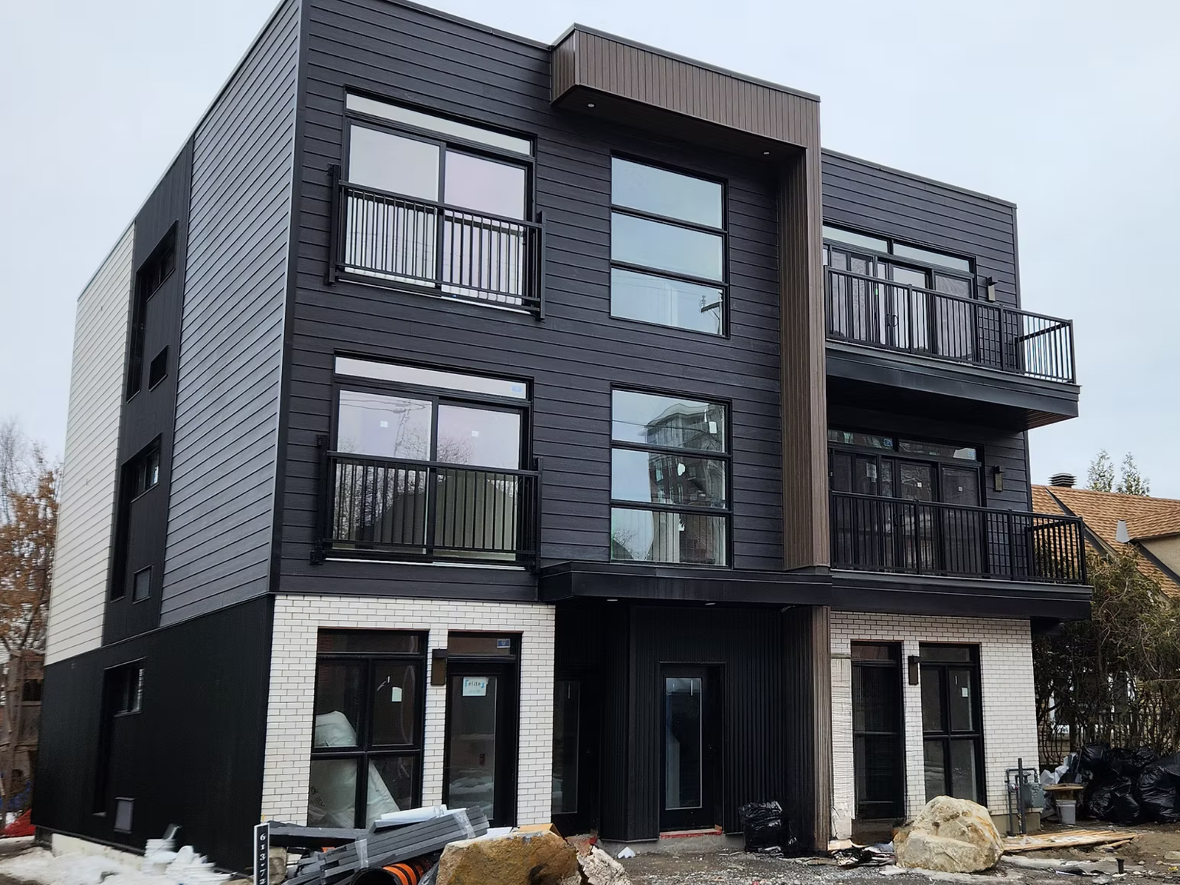 Complete exterior image of a multi-unit residential infill titled "Grant".