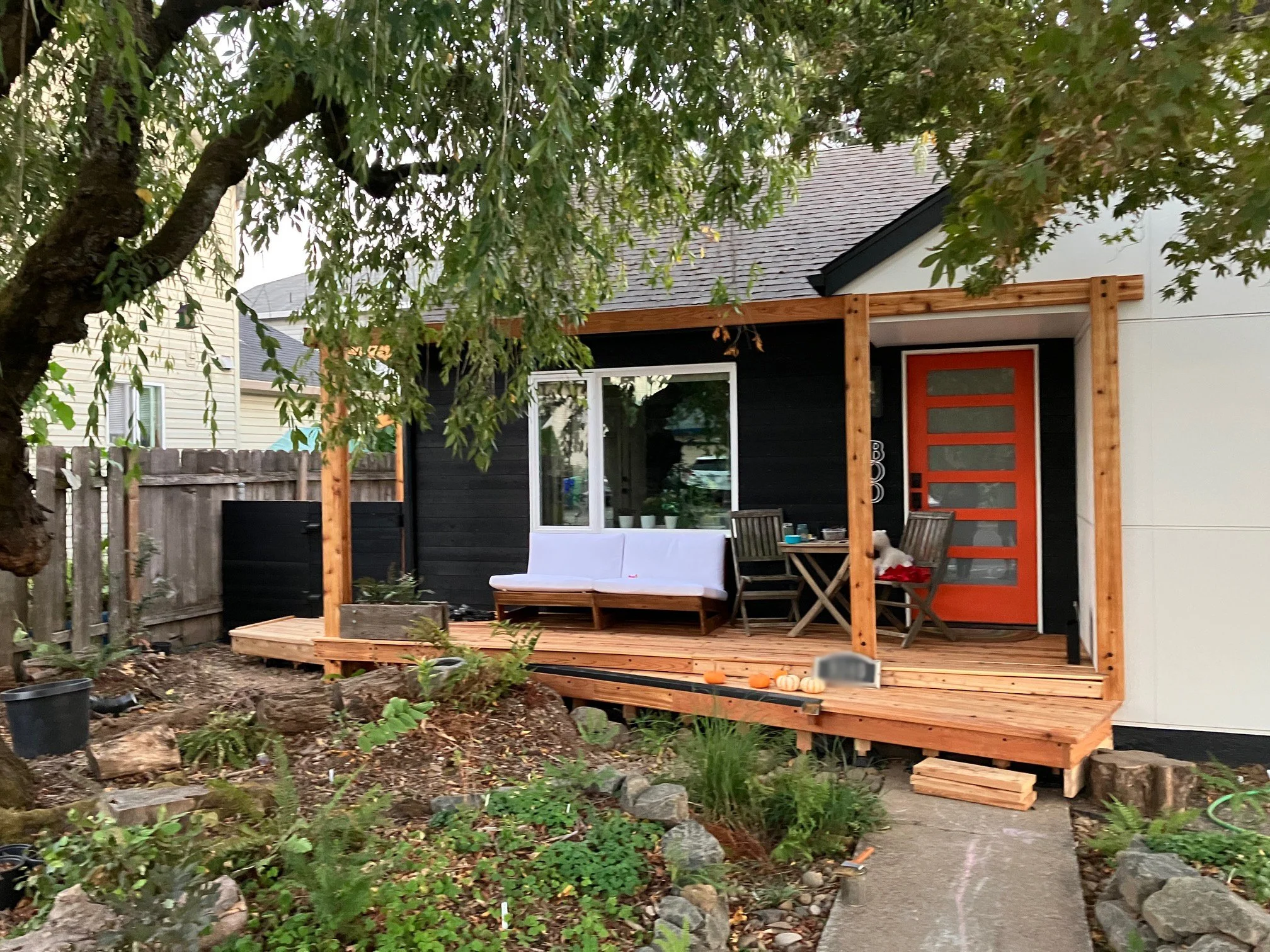 A wood deck was added to the front to create a sitting area where the client could sit and enjoy their new garden. A special channel was built into the deck to carry rainwater from the downspout to the rain garden by the front door. During a rainstor