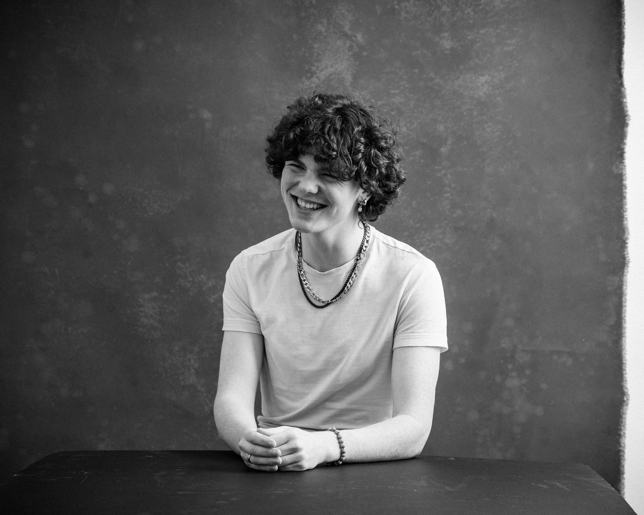 Black and white photo of person looking to the side smiling