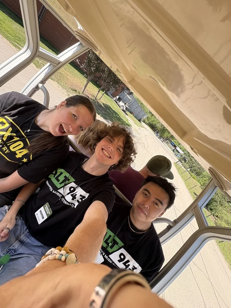 3 people on golf cart taking a selfie