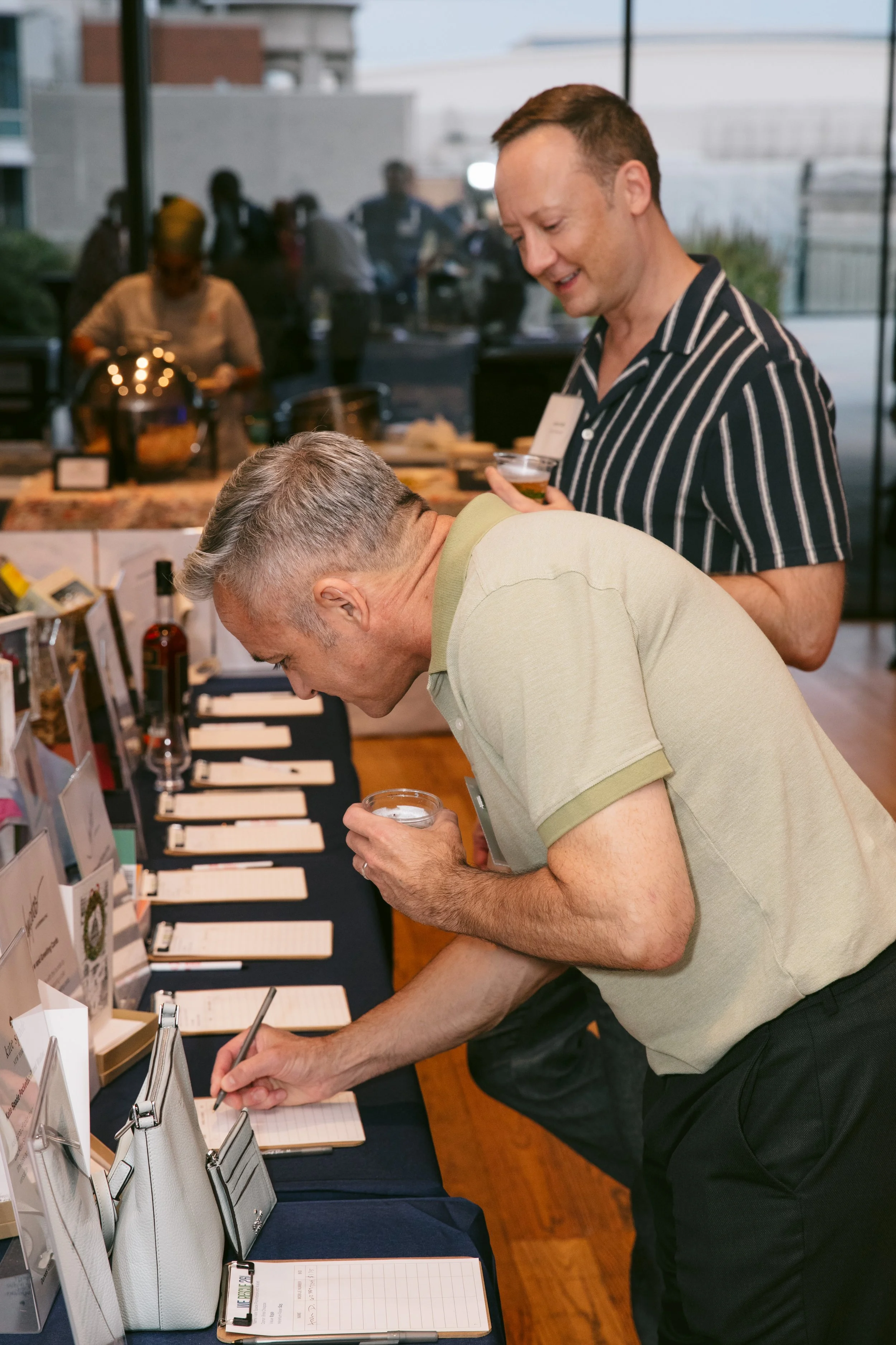 Guests bidding in 2026 silent auction