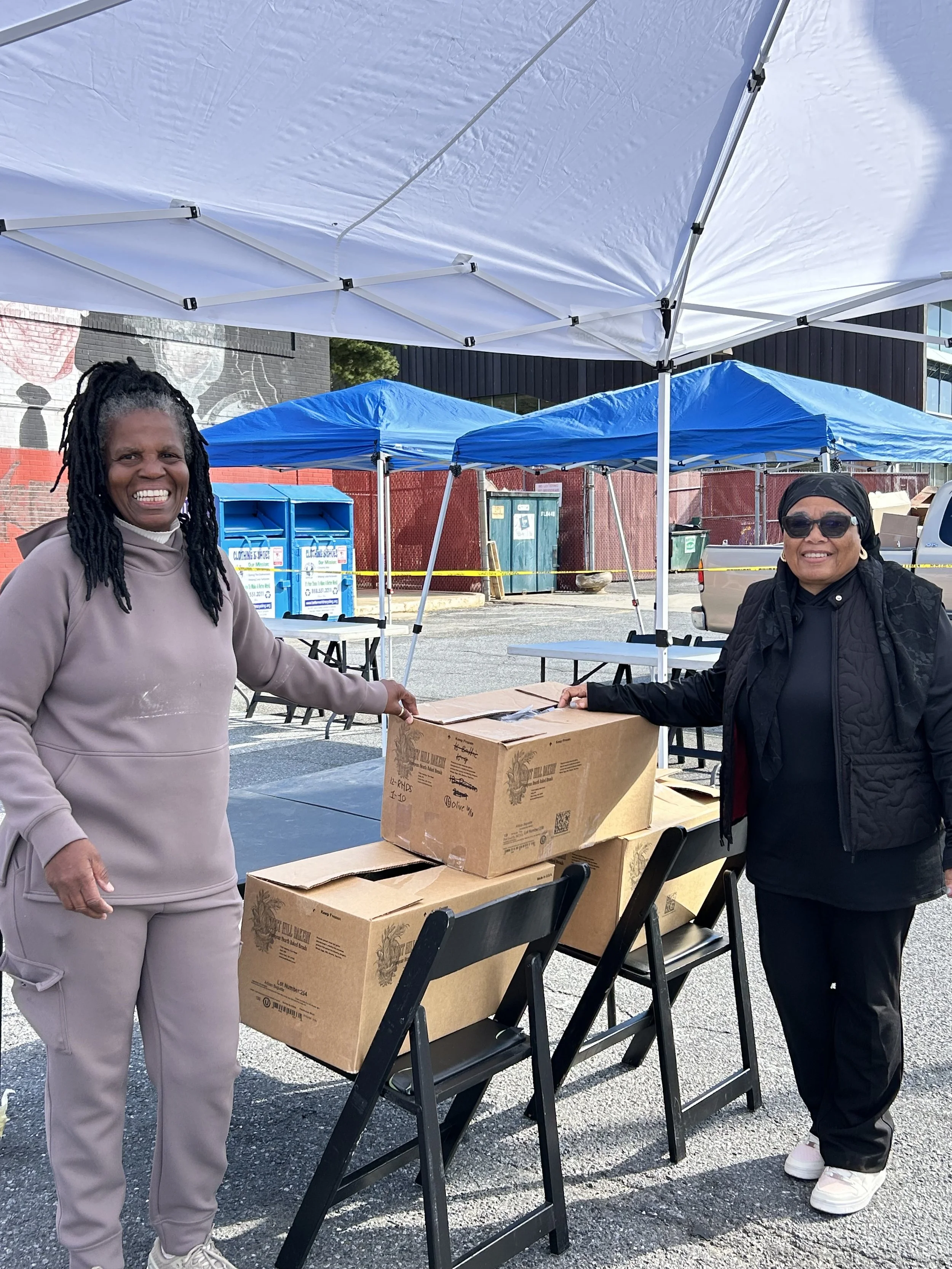 Two smiling organizers of the Ward 7 Faith Leaders during a Good Neighbors Market in October 2025