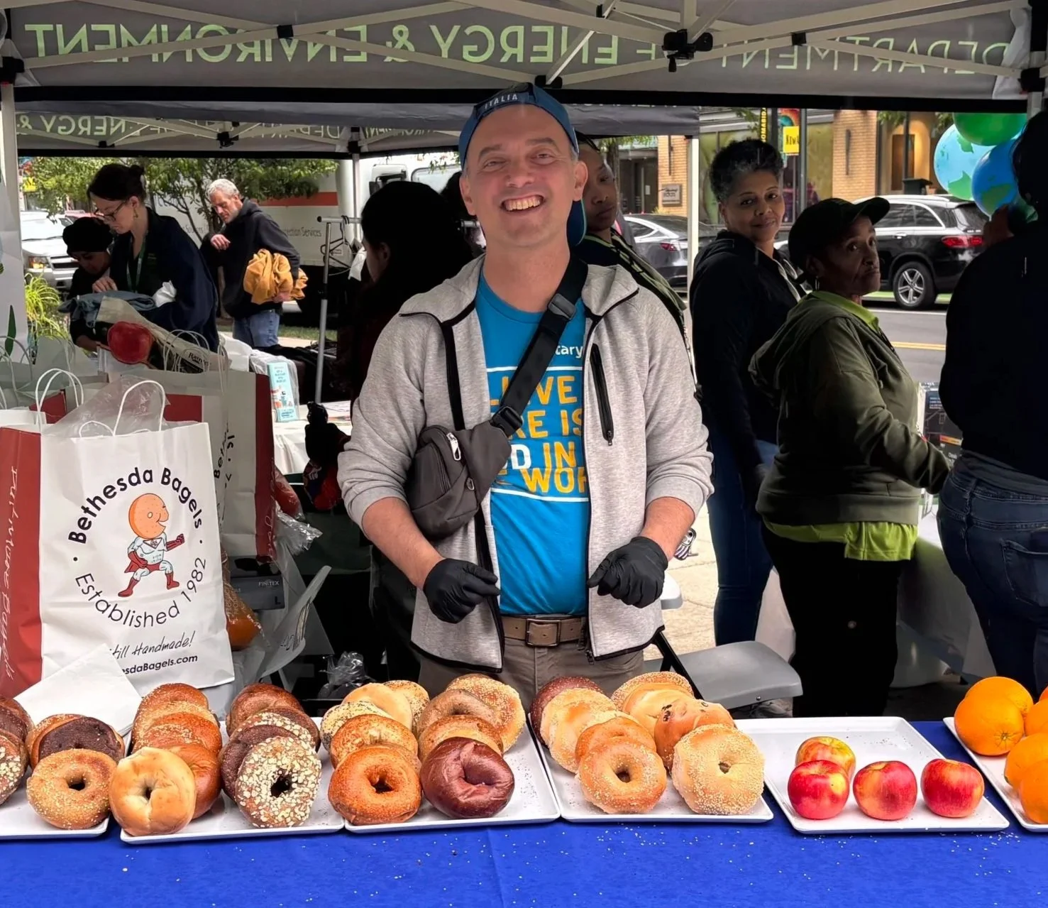 Every Neighbor United for Food Executive Director Tony Panzera giving away rescued bagels at an Earth Day event