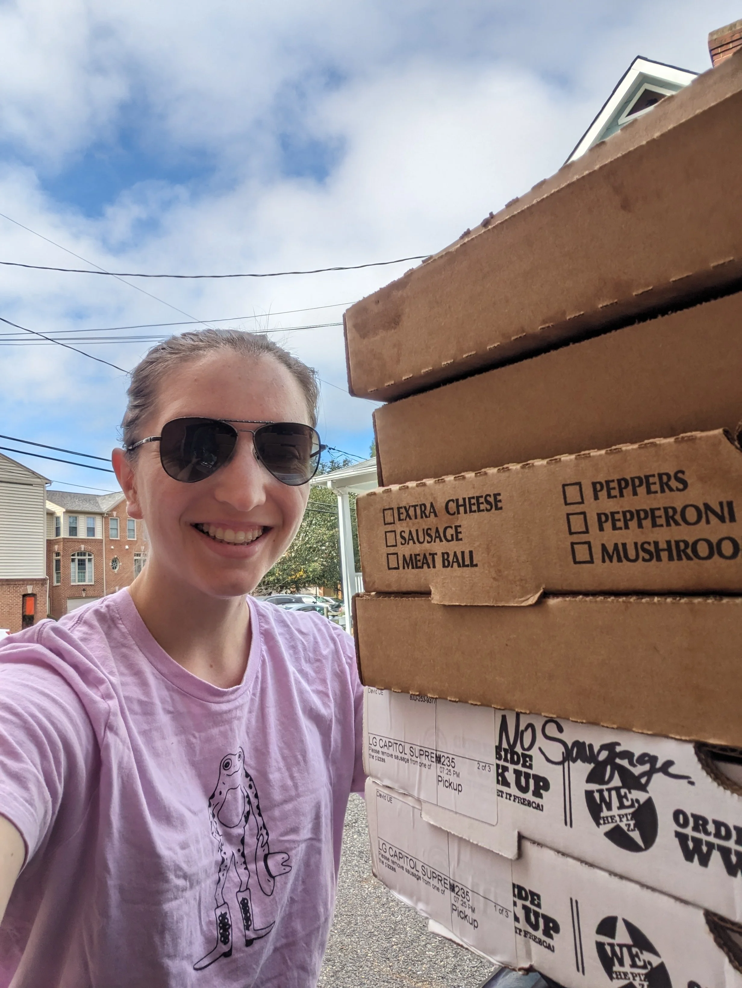 Every Neighbor United for Food's Director of Data & Communications Eva Reynolds smiling during a food rescue with donated pizza