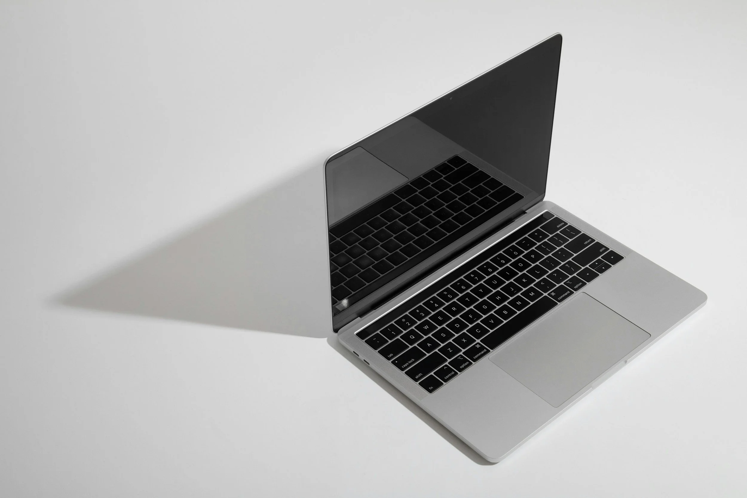 Laptop placed on a table in a simple, minimal setting.